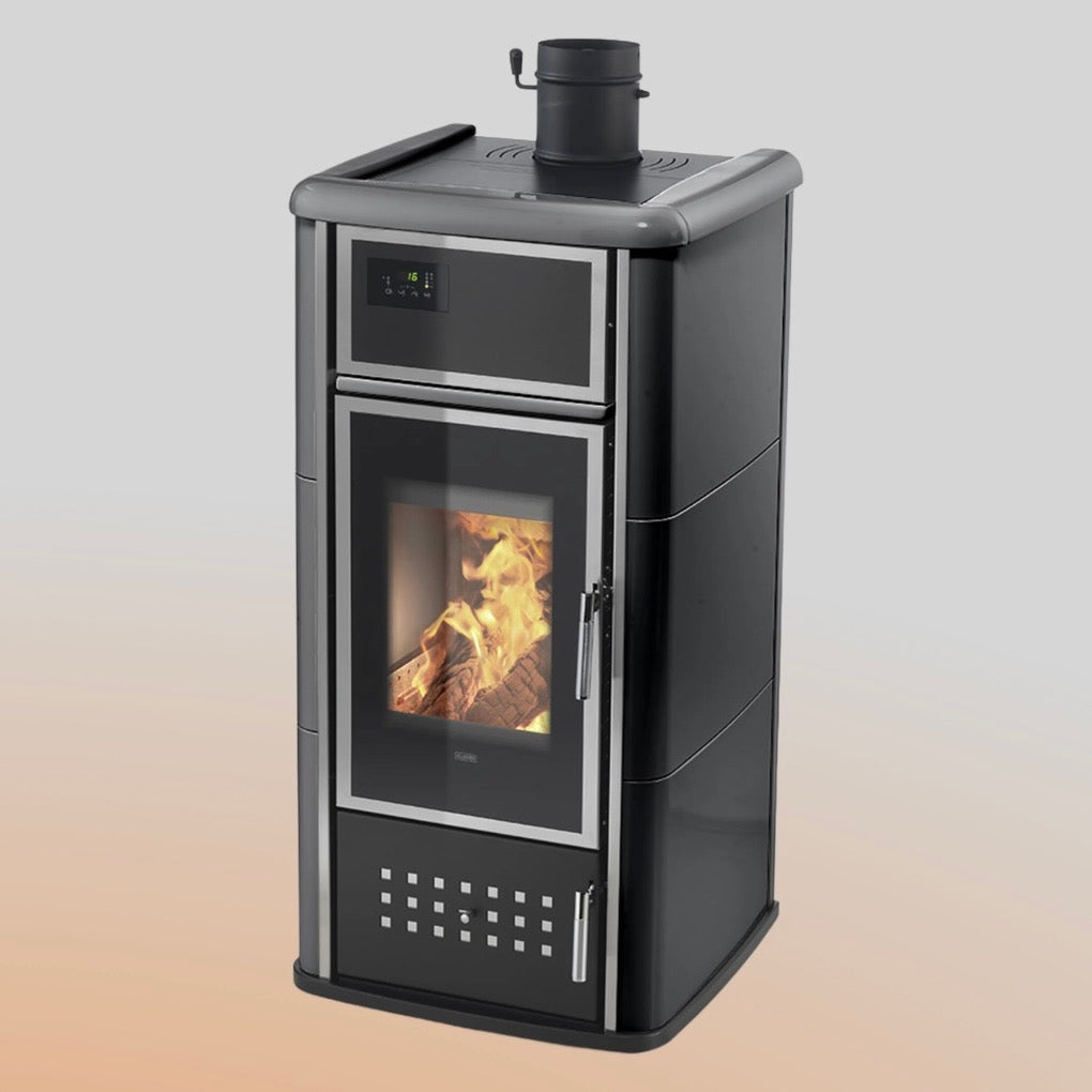 Termostufa a legna Klover Belvedere 20 con vetro frontale e doppia uscita, in ambientazione domestica rustica
