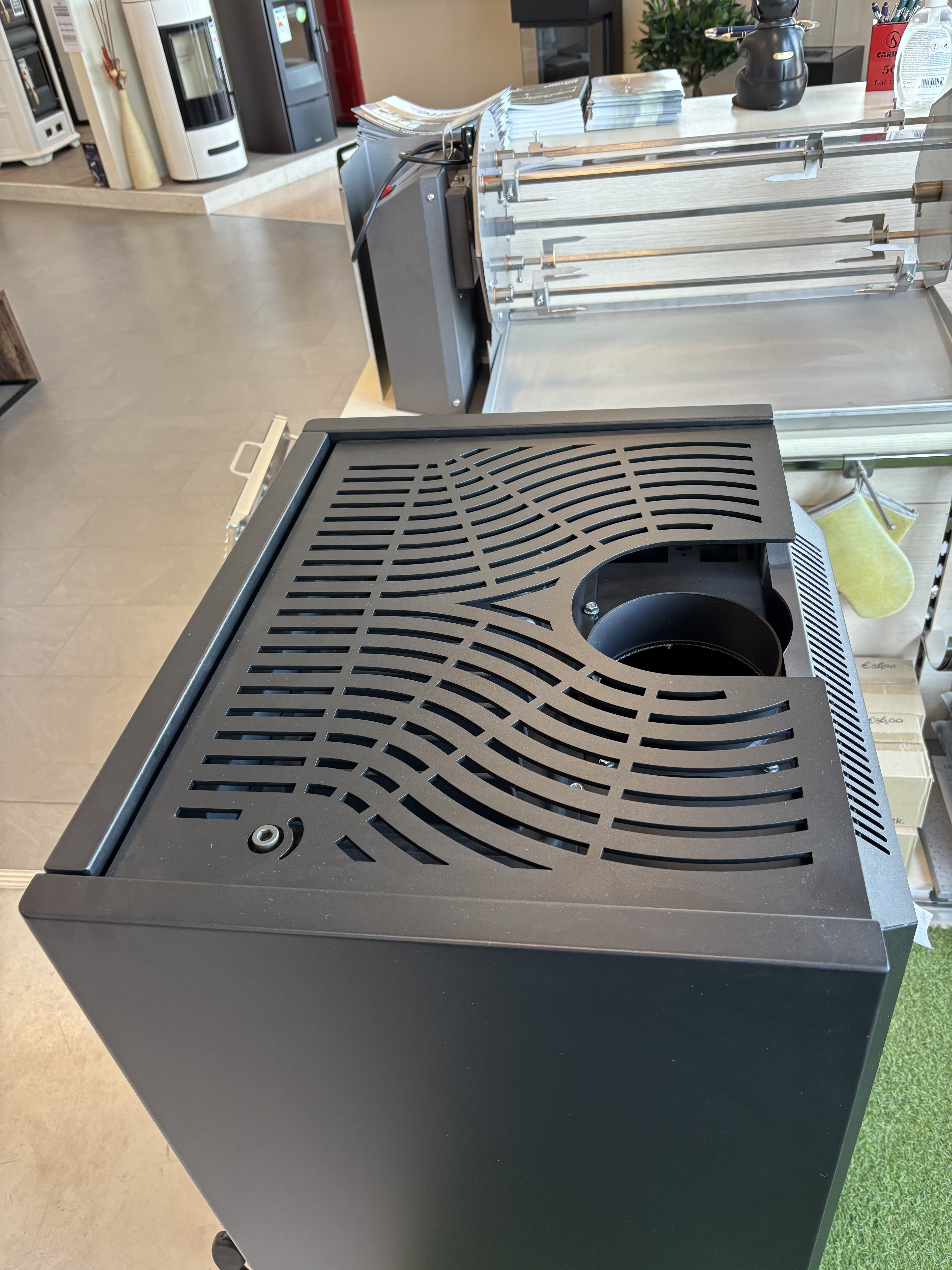 Stufa a legna Dielle Stufe Ghibli Wood Steel Nero con design moderno in acciaio nero, visibile con porta e dettagli in azione.