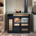 Termostufa a legna Klover Storica con forno, in acciaio nero e porta in vetro, ideale per riscaldamento domestico.